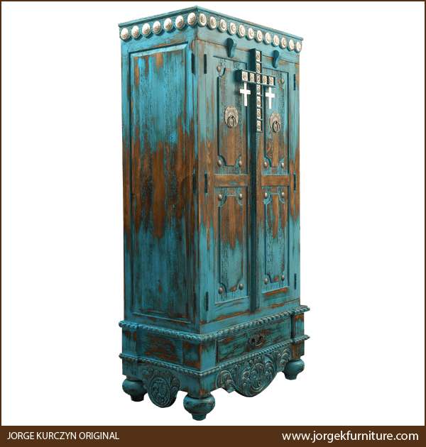 Three-quarter angle of Las Cruces armoire showing silver cross and tapered feet.