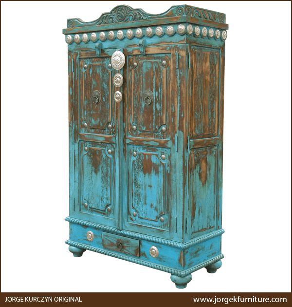 Three-quarter angle of Las Cruces 2 armoire showing arched crest and tapered feet