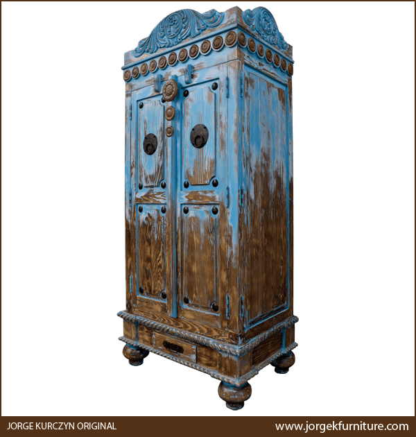Three-quarter angle of Las Cruces 4 armoire showing carved details and tapered feet