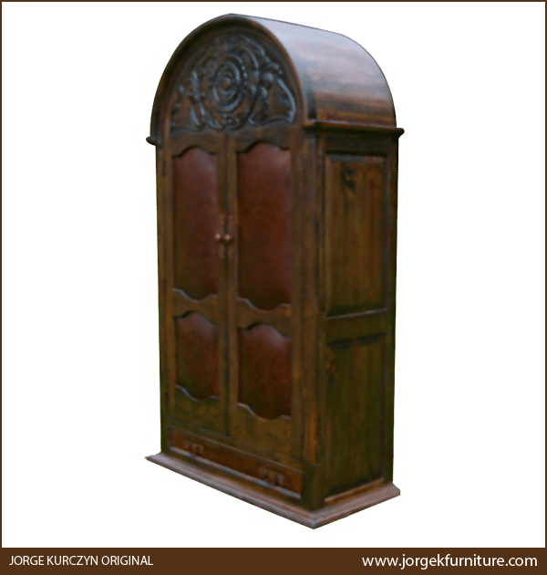 Three-quarter angle of La Negra Elegante armoire showing carved scroll details and molding base
