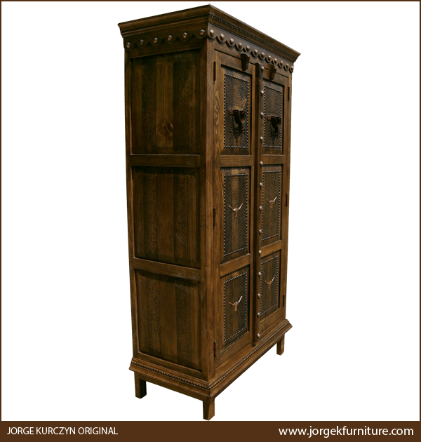 Three-quarter angle of Rio Pecas armoire showing copper conchos, gilt nail accents, and square legs