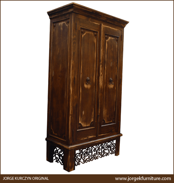 Three-quarter angle of Castillo armoire showing ornamental ironwork and square legs