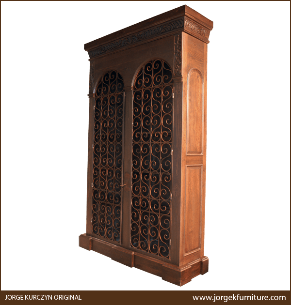 Three-quarter angle of Montecristo armoire showing carved crown molding and ironwork details