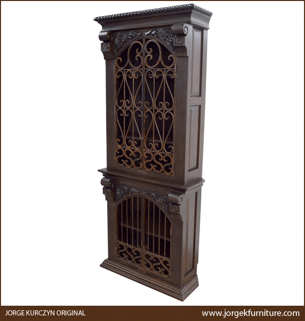 Three-quarter angle of Spanish Colonial Armoire showing carved floral details and iron accents