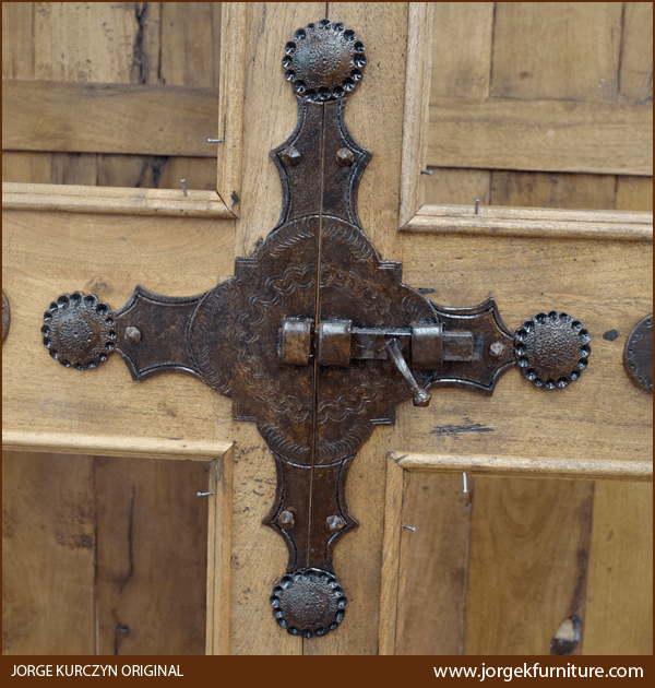 Close-up of hand forged iron lock with concho design on Spanish Colonial Armoire