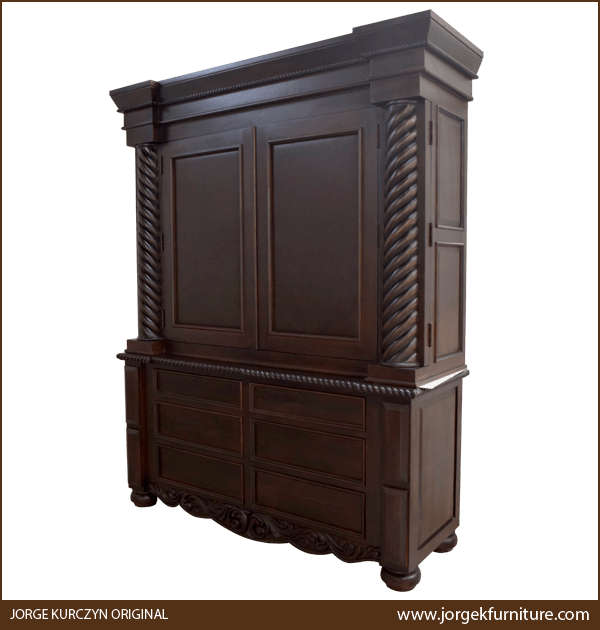 Three-quarter angle of dark finish armoire showing staggered crown molding and drawer layout