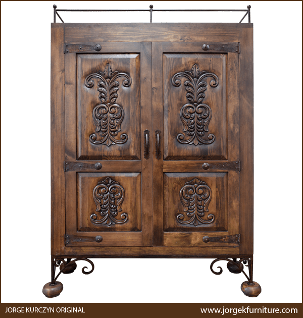 Front view of Spanish Colonial Armoire with hand-carved scroll designs and forged iron accents