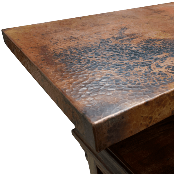 Detail of hand-hammered copper countertop with rich patina and texture
