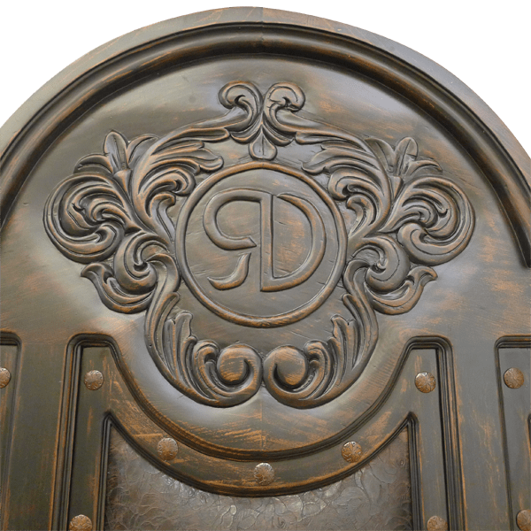 Detail of headboard carving with ranch logo, scrollwork, and iron accents