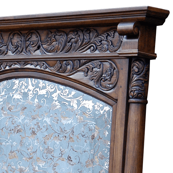Close-up of headboard carvings and arched blue and silver leather panel on Spanish colonial bed