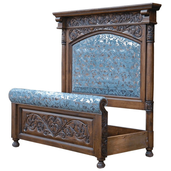 Semi-front view of Spanish colonial bed with hand-carved headboard and blue patterned leather