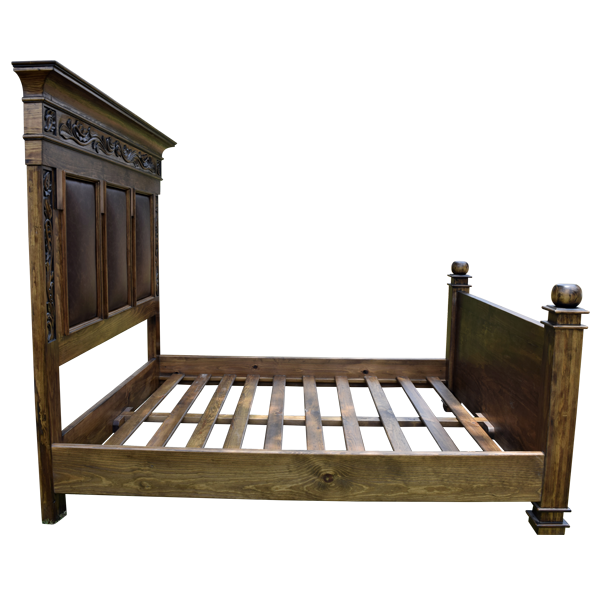 Side view of Spanish colonial bed with carved wood legs and brown leather panels