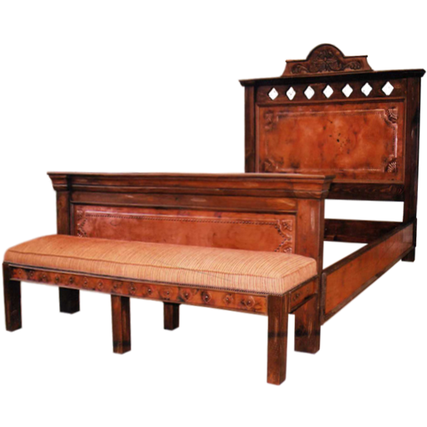 Semi-front view of Spanish colonial bed with hammered copper panels, carved crest, and upholstered bench