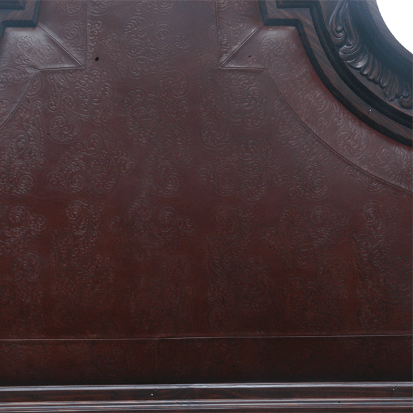 Detail of headboard with tooled leather and Western floral scroll designs
