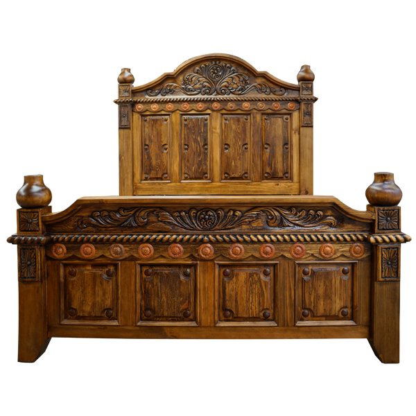 Front view of Spanish colonial bed with copper conchos and carved crest