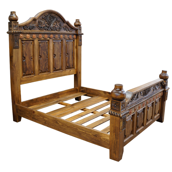 Semi-front view of Spanish colonial bed with hand carved wood and copper details