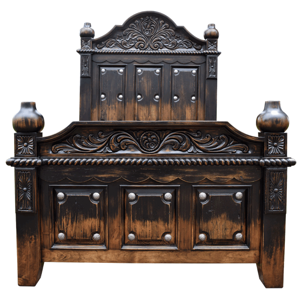 Front view of Spanish colonial bed with silver copper conchos and scalloped carving in antique finish