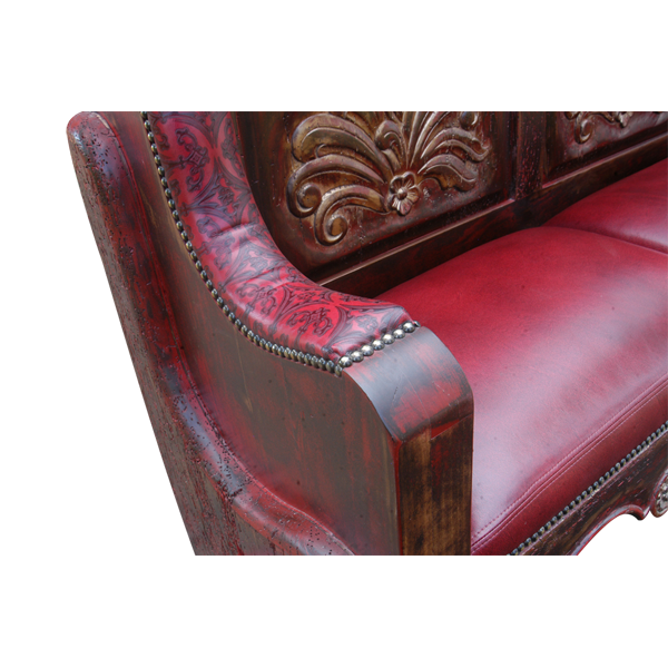 Detail of bench with red and brown stain, embossed leather, gilt nails, and gold leaf carving