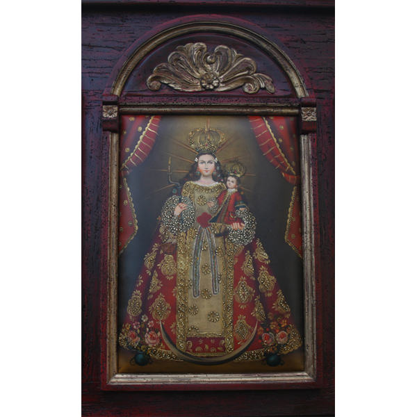 Detail of headboard with religious oil painting and gold scroll carving