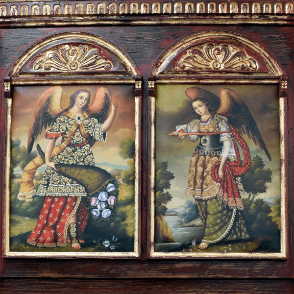 Detail of headboard with two religious oil paintings and gold scrollwork