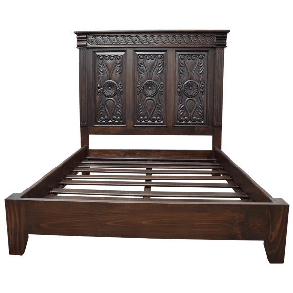 Front view of Spanish colonial bed with floral and scroll carving and fluted uprights
