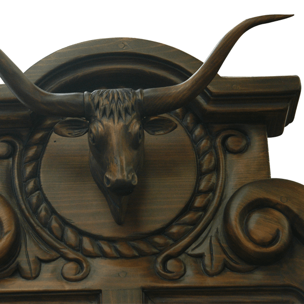 Detail of hand carved bull crest with twist rope and scroll ornamentation