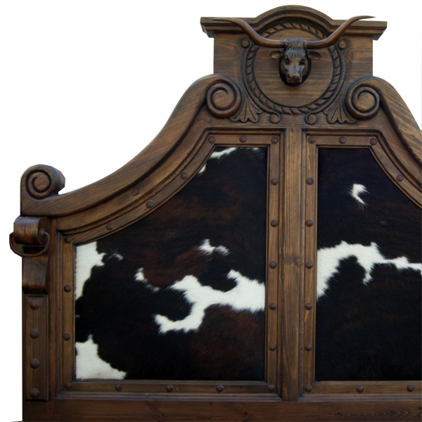 Detail of headboard with carved bull crest and natural cowhide texture
