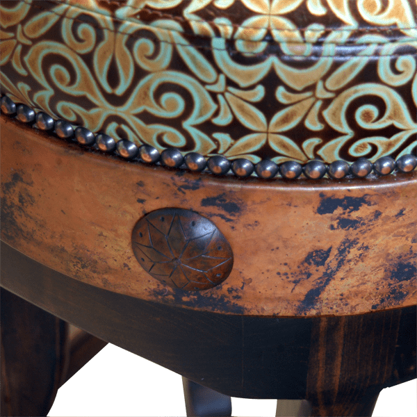 Close-up of turquoise embossed leather, copper band, hand tacks and iron conchos